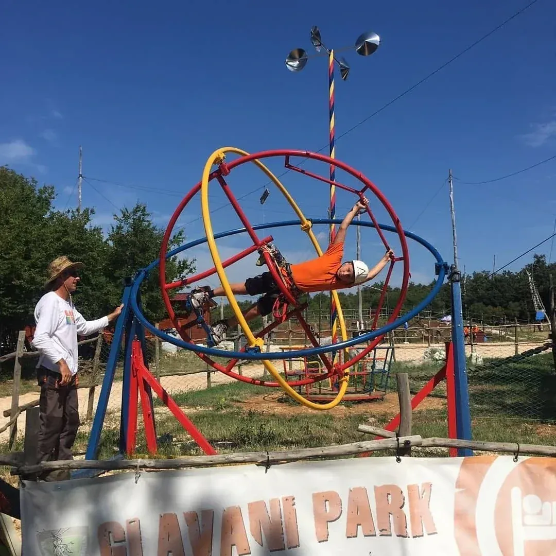 Guest in the Aerotrim human gyroscope with instructor at Glavani Park, Istria