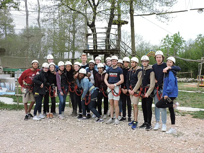 School group in helmets and harnesses ready for the high-ropes course at Glavani Park
