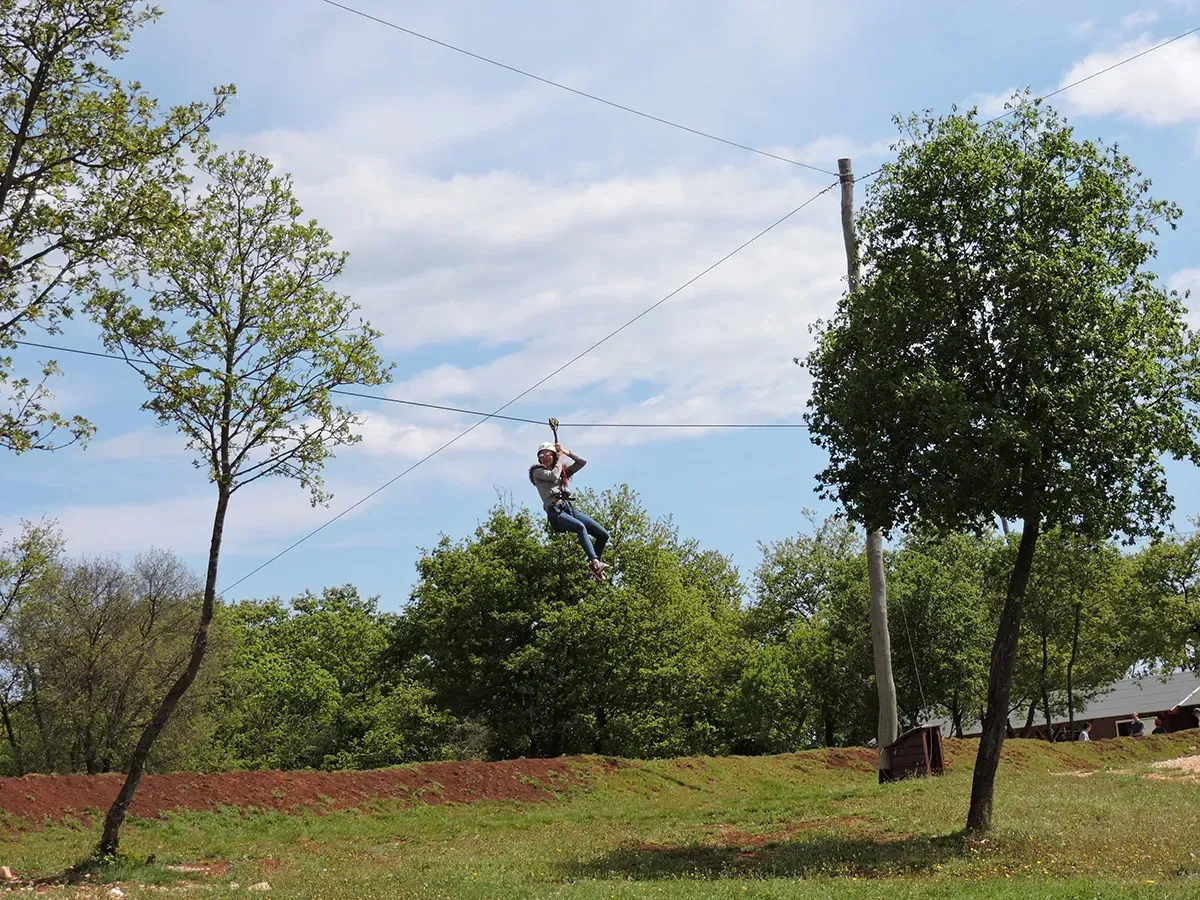 Guest on the blue treetop course high above the forest floor at Glavani Park, Istria