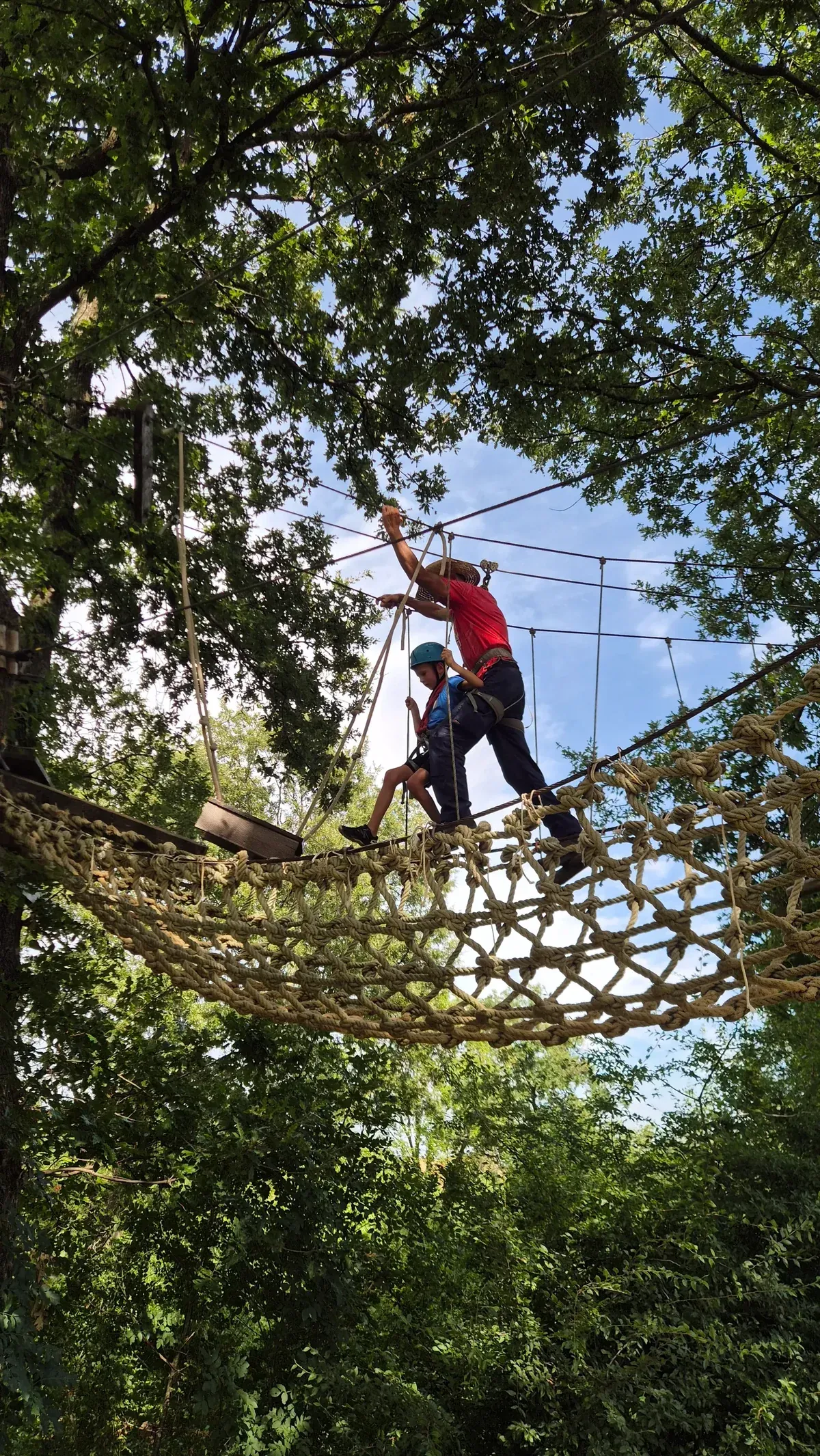 Guest on the treetop course with instructor at Glavani Park, Istria